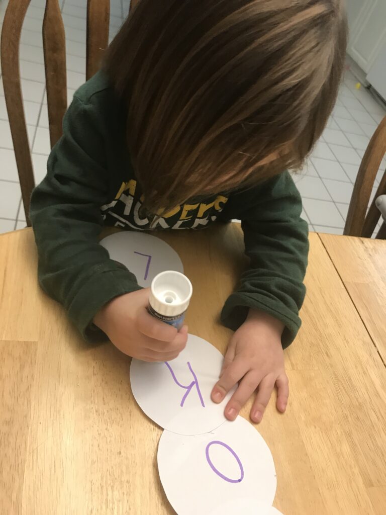 Child Making Snowman Name Craft